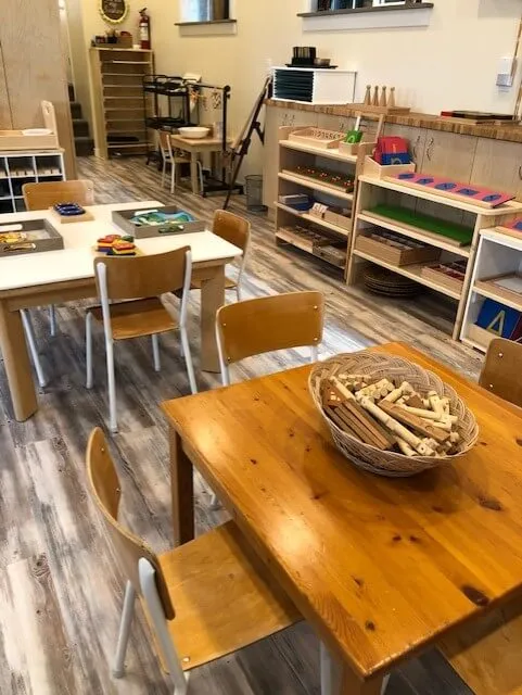 Inside the Coronation Montessori classroom: low wooden shelves with carefully arranged materials