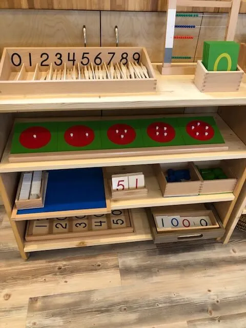 Montessori games and puzzles laid out on a low table