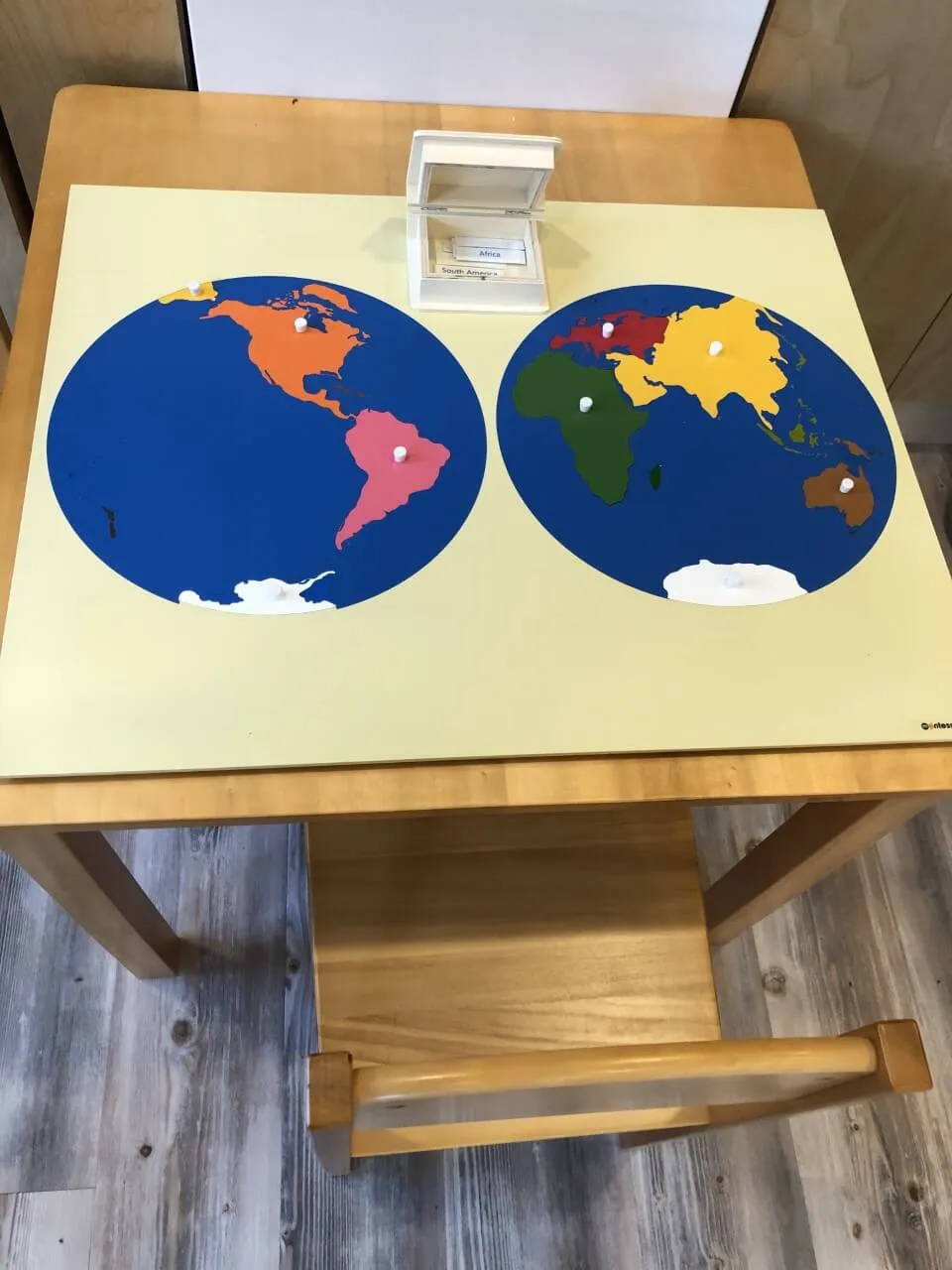 A large world map puzzle in the classroom